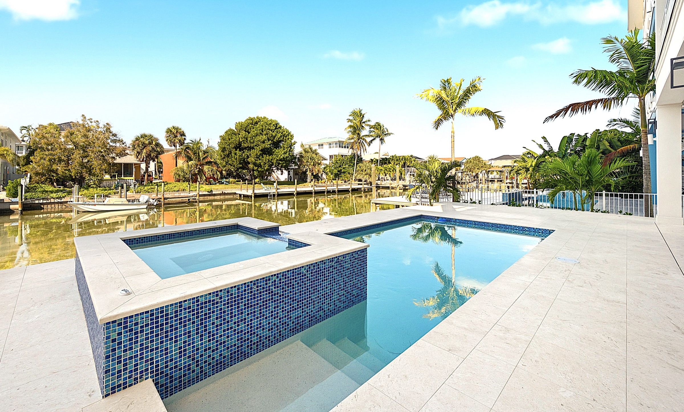 Waterfront pool and spa at dusk — Coastal Residence by Afonova Nelson Homes