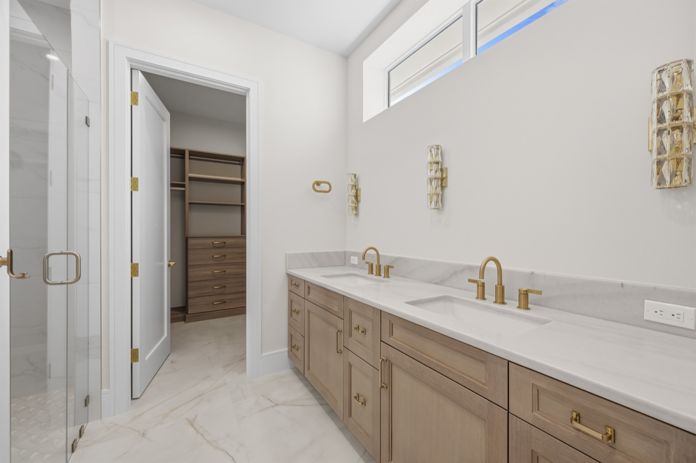 Primary bath with white-oak vanities and marble